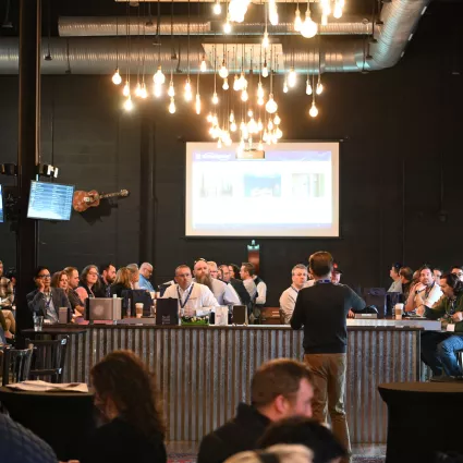 Audience at an event watches a speaker.