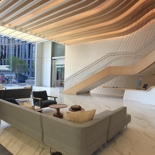 A lobby with a couch and large staircase