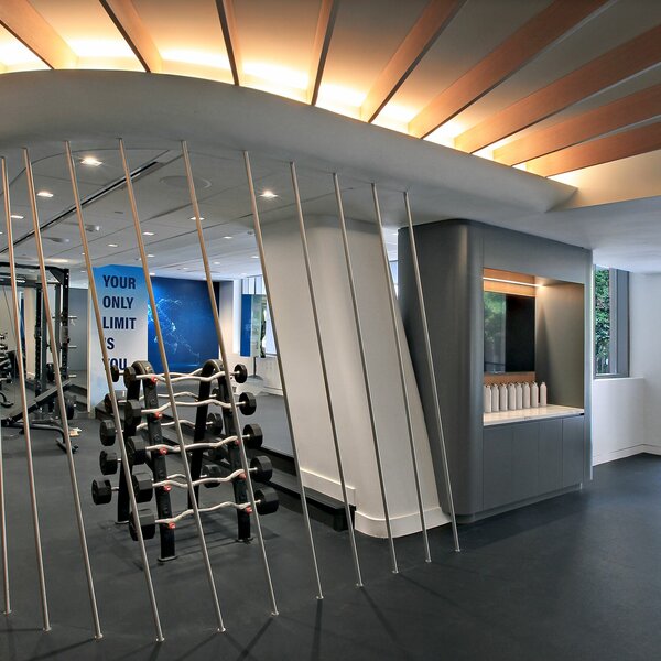 A shot of a renovated fitness center that includes a rack of free weights and a wall decal that reads "Your Only Limit Is You"