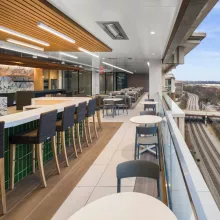 Terrace with long table and chairs, with a view of the outdoors