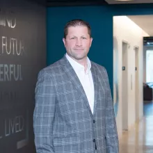 Man in professional wear standing in office hallway