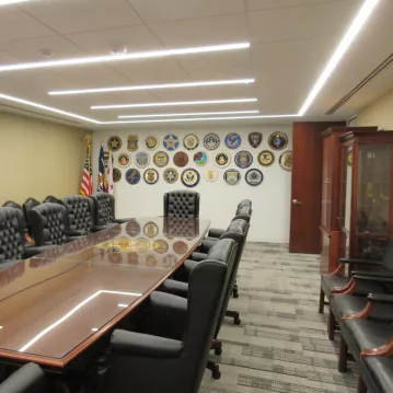 Conferencing room with a large rectangular table and chairs