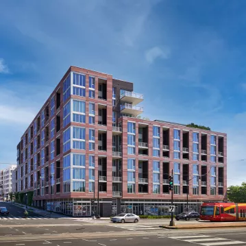 Exterior shot of an apartment building during the day.