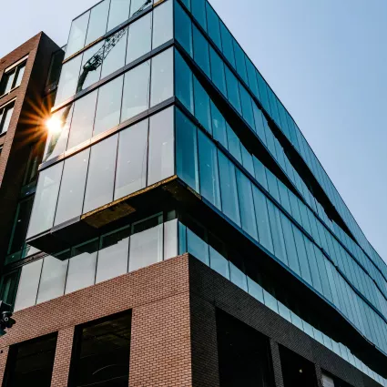 Exterior Shot of an Office Building, with glass facade and concrete.