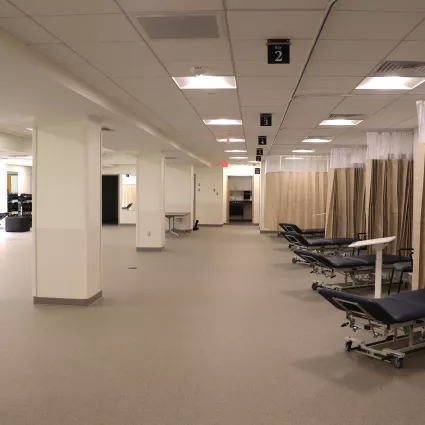 Orthopedic gym space that includes benches, chairs, and places to stretch.