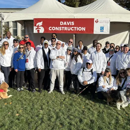 Group photo of walking team wearing matching white sweaters w