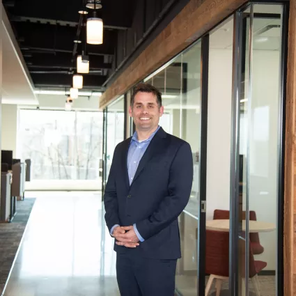 Man standing in office hallway