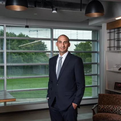 Man in professional wear standing in office hallway