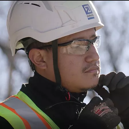 Project team member securing hard hat