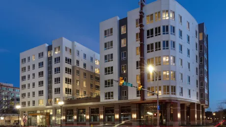 Exterior shot of an apartment building at night.