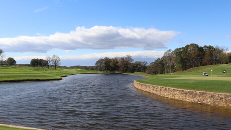 Landscape shot of a water feature in a golf course.