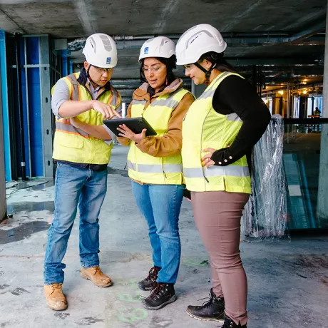 project team reviewing site plans on active jobsite