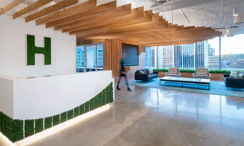 Office reception desk with ceiling wood panels