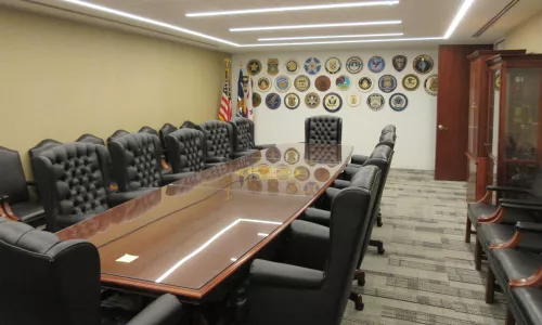 Conferencing room with a large rectangular table and chairs