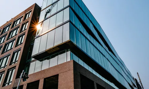 Exterior Shot of an Office Building, with glass facade and concrete.