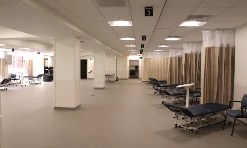 Orthopedic gym space that includes benches, chairs, and places to stretch.