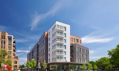 Exterior shot of an apartment building in the day.