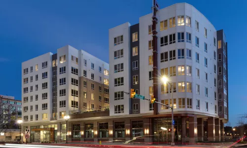 Exterior shot of an apartment building at night.