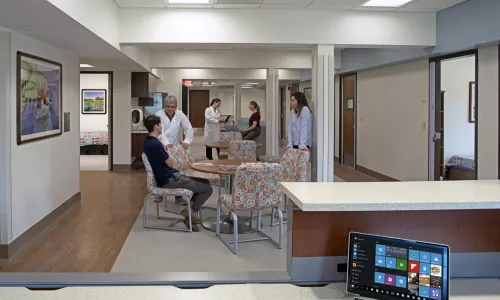 Patients and caregivers seated in common area