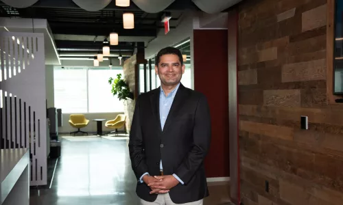 Man in professional wear standing in office hallway