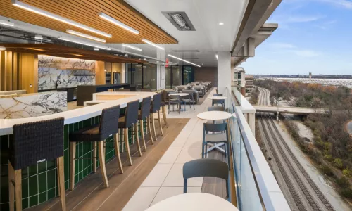 Terrace with long table and chairs, with a view of the outdoors