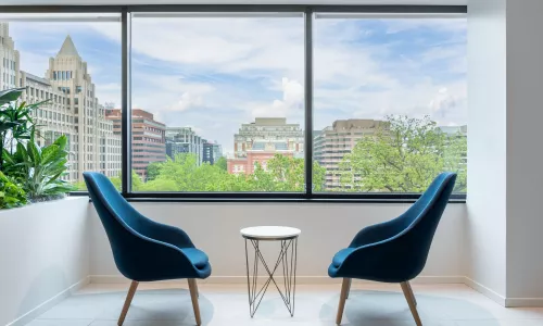 Two office chairs in front of a window