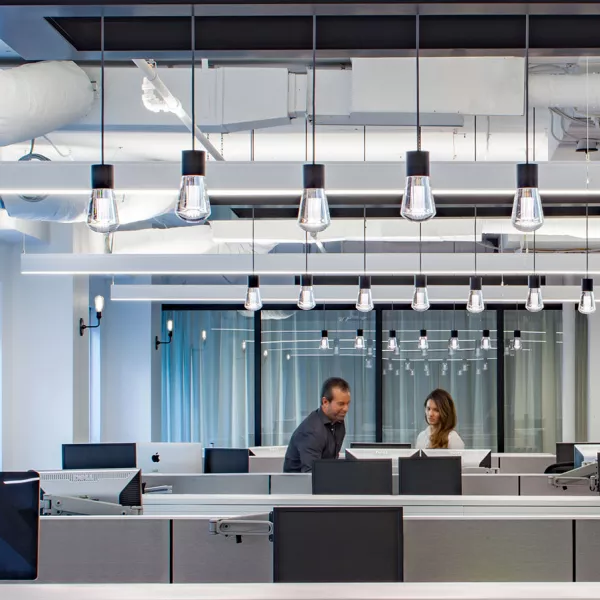 open workspace with two employees in background