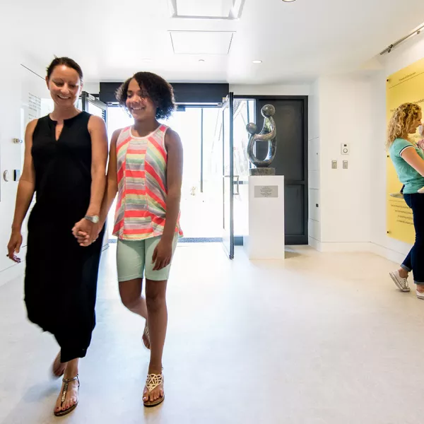 Two people walking in hall