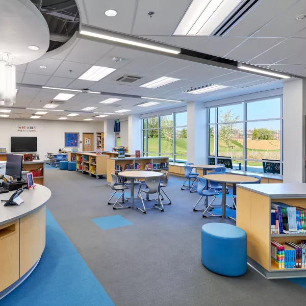 School library with bookshelves and a front desk.