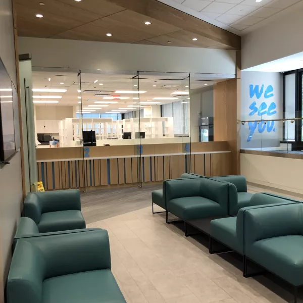 A pharmacy with chairs and a front desk.