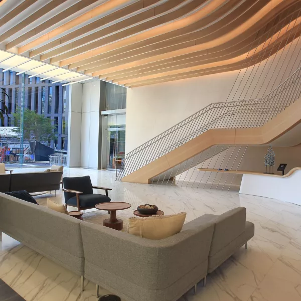 A lobby with a couch and large staircase