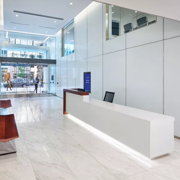 A lobby with a desk and benches.