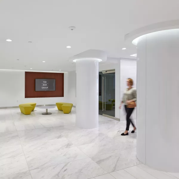 A woman stands in a hallway.