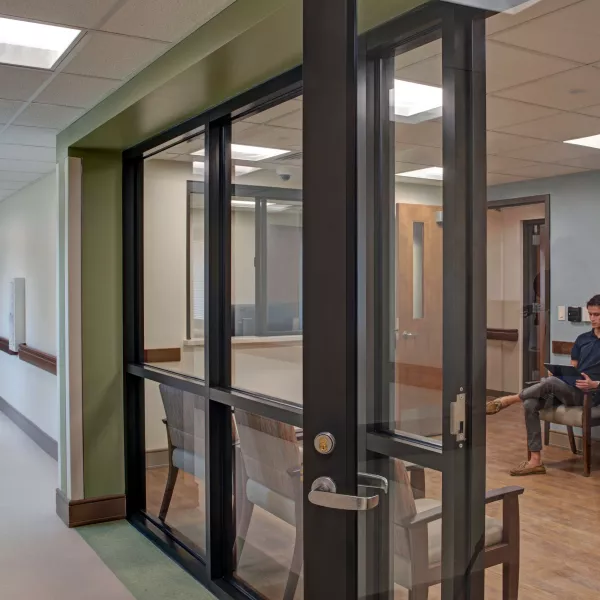 Glass door and panels separating hall and seating area