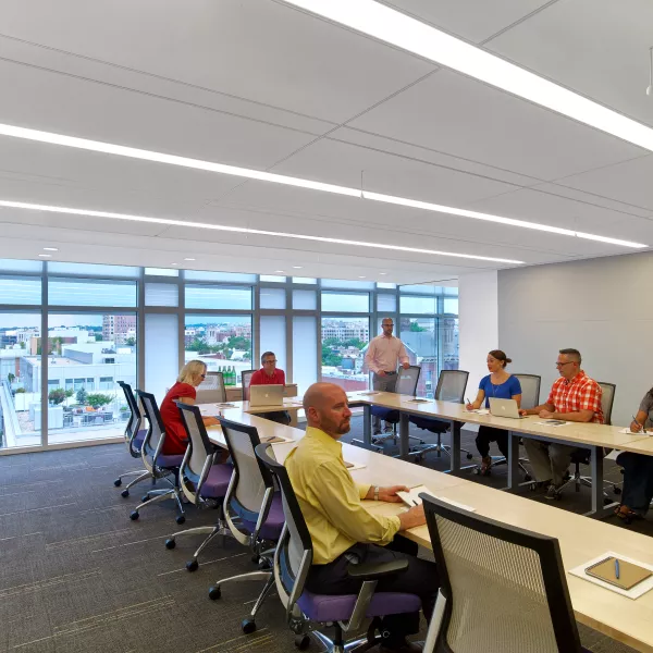 Conference room with people seated around table