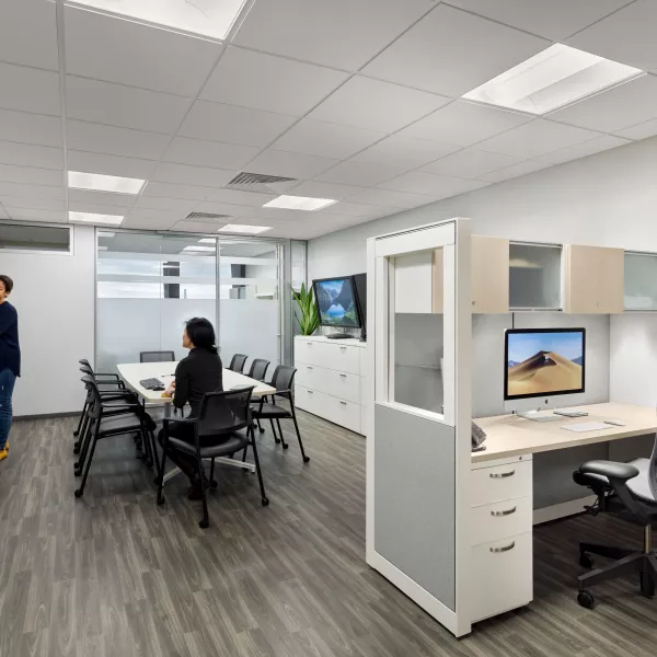 Medical office with large whiteboard and employees discussing