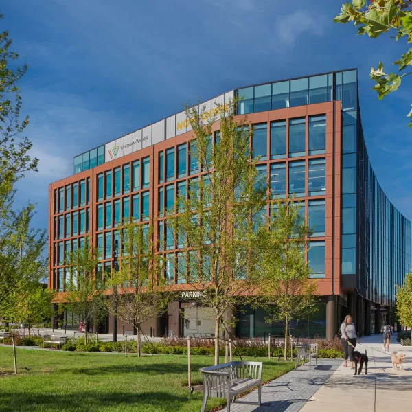 Greenspace outside brick and glass building