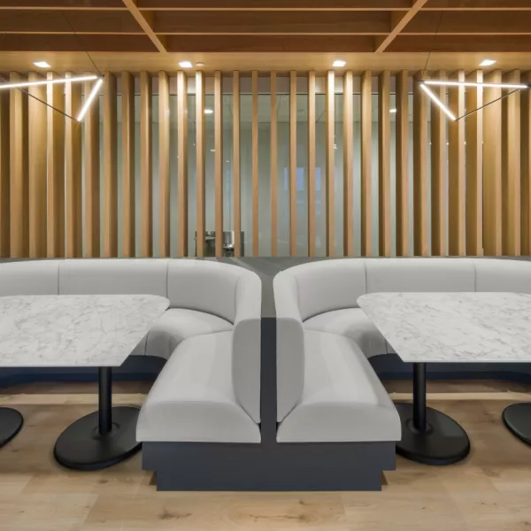 Two collaborative spaces inside an office's amenities floor.