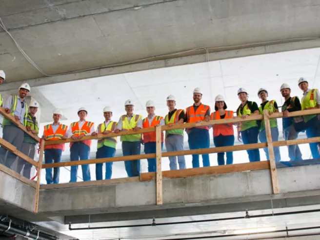 upward view of people lined up with construction gear on posing for picture