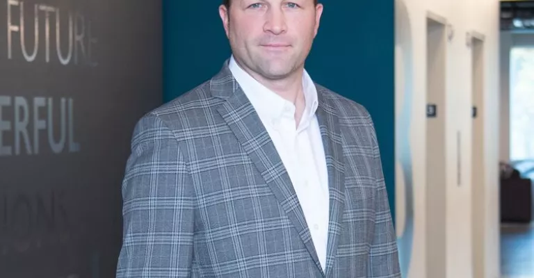 Man in professional wear standing in office hallway